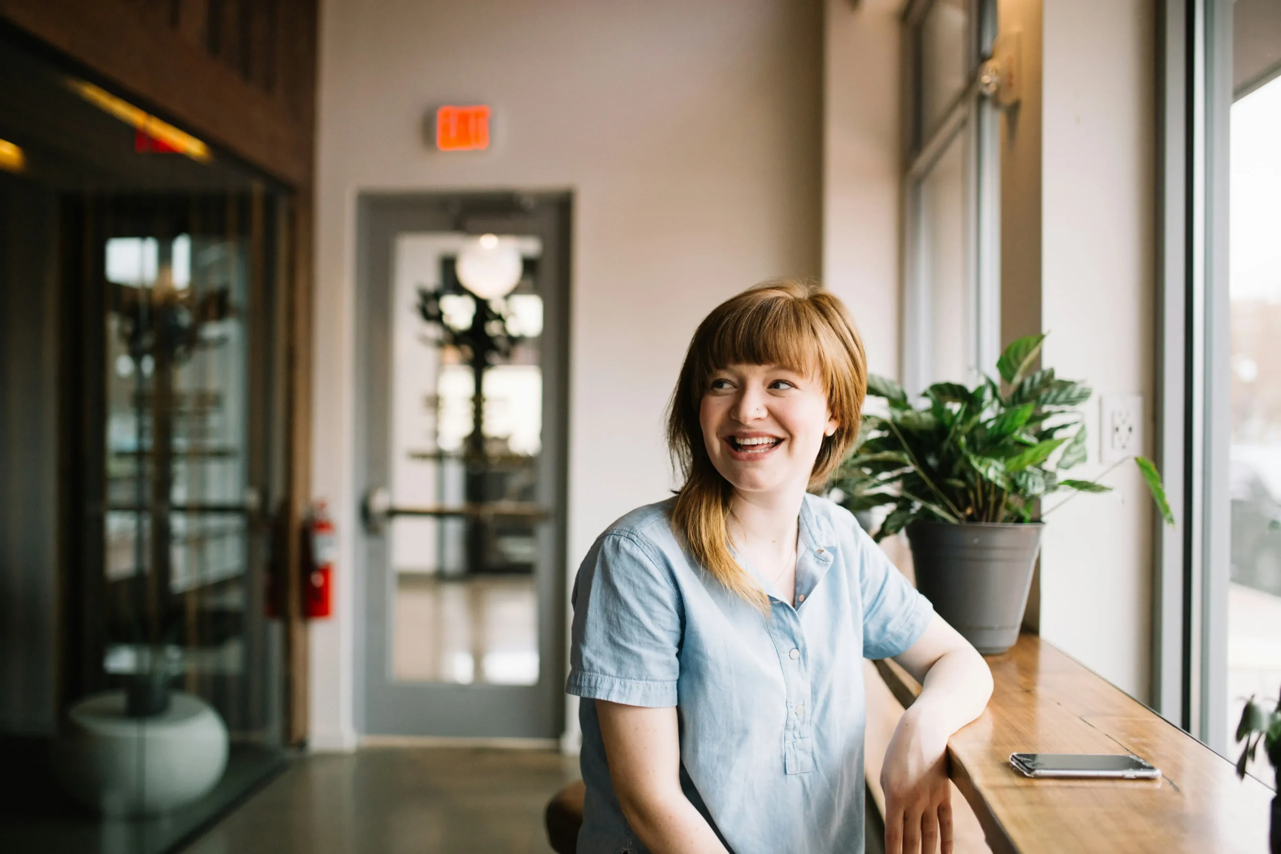 female customer feels customer satisfaction sitting happily in a waiting area.