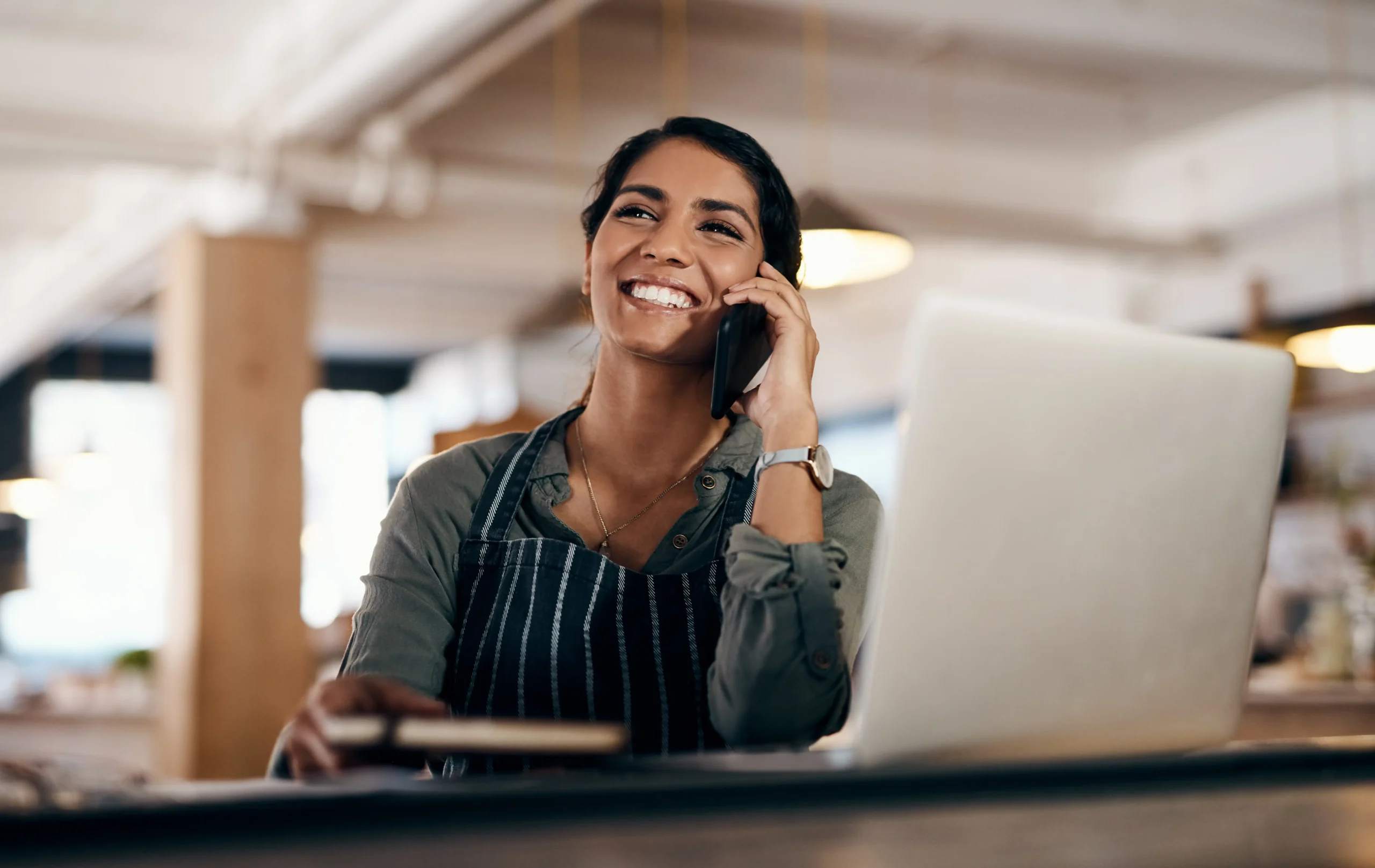 Female business owner gives excellent customer service over the phone.