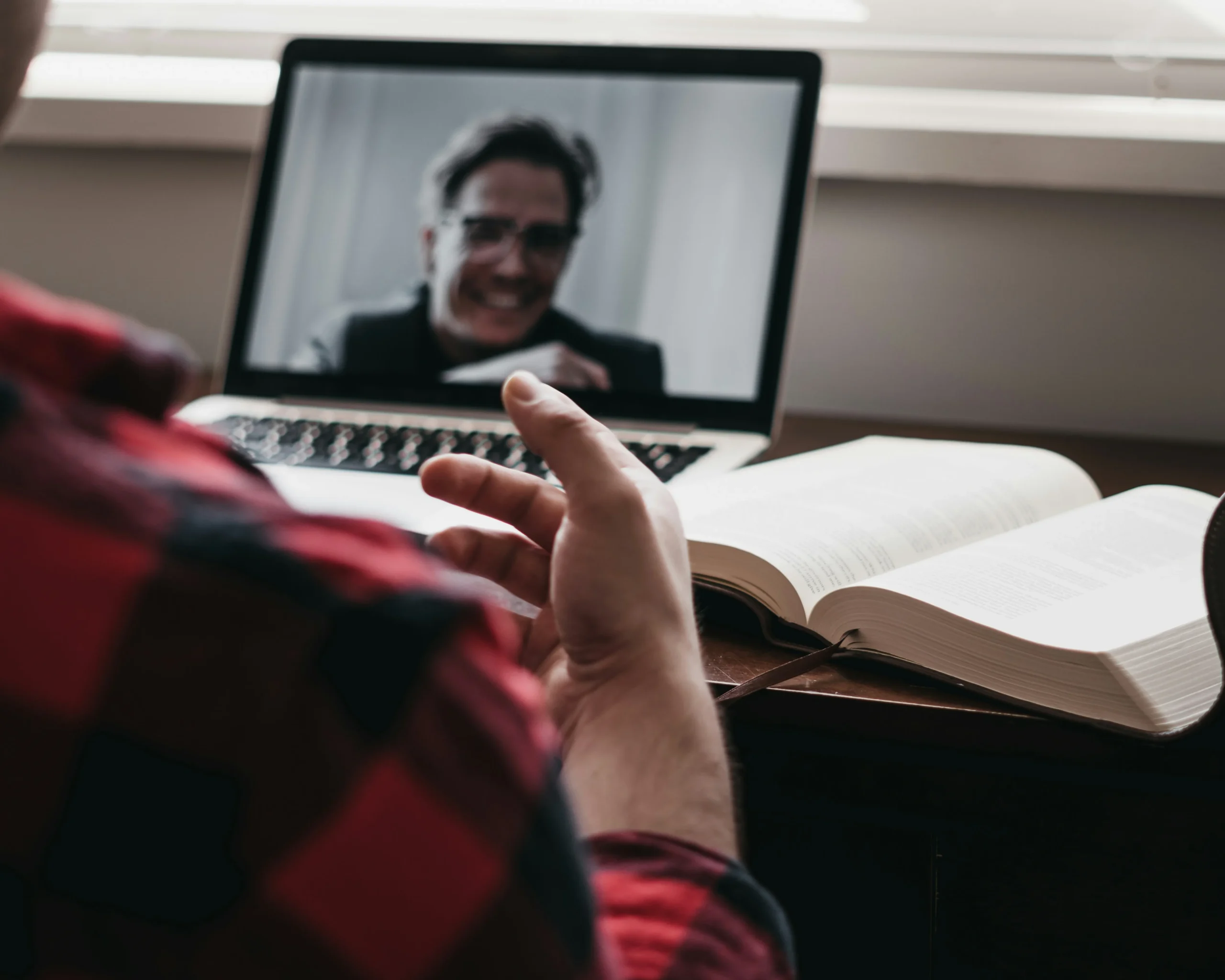 male business owner utilises modern video conferencing from home.