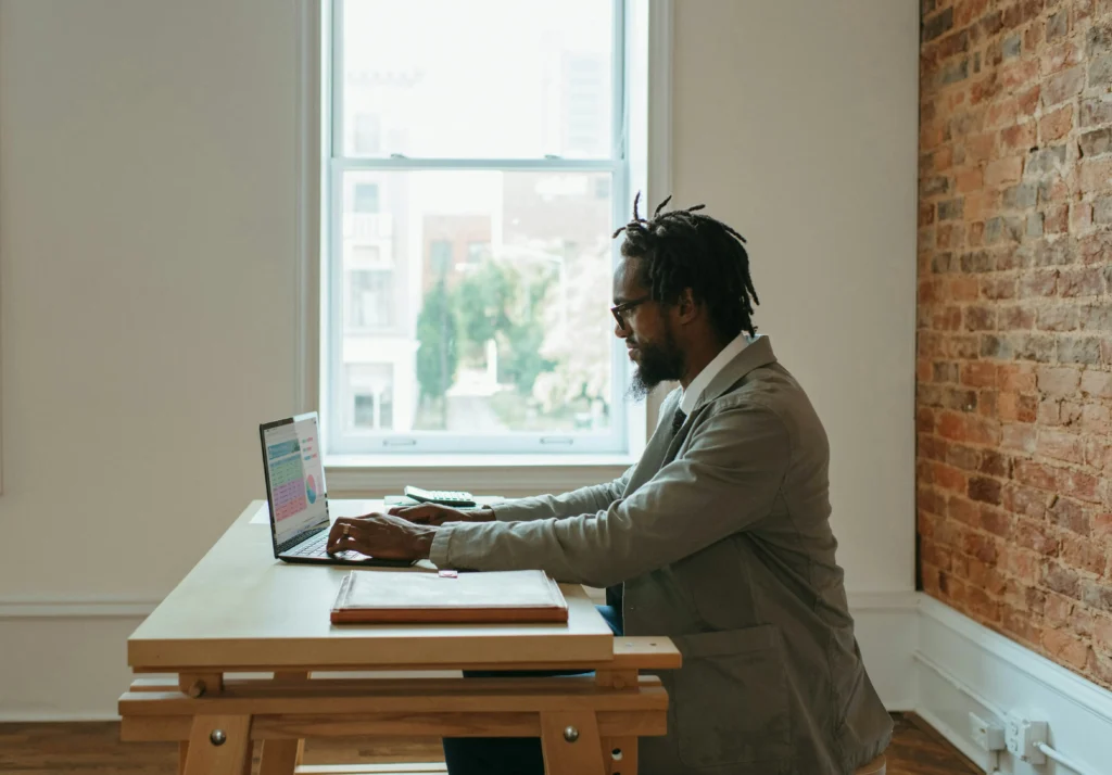 male employee enjoys remote working within a minimal space.