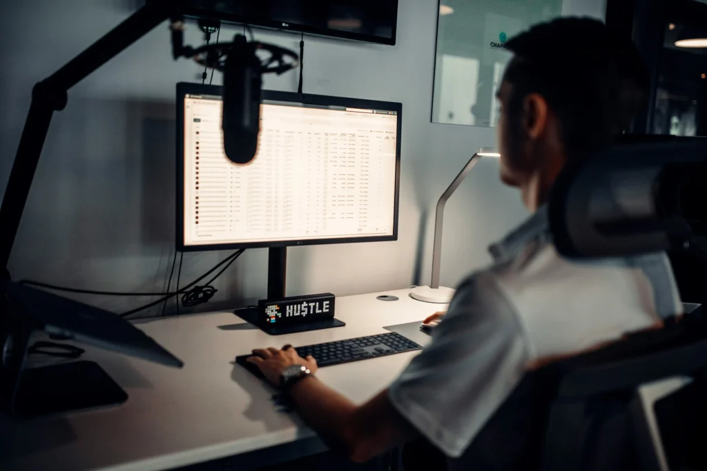a young business owner sits behind a desk and looks through their recorded calls.