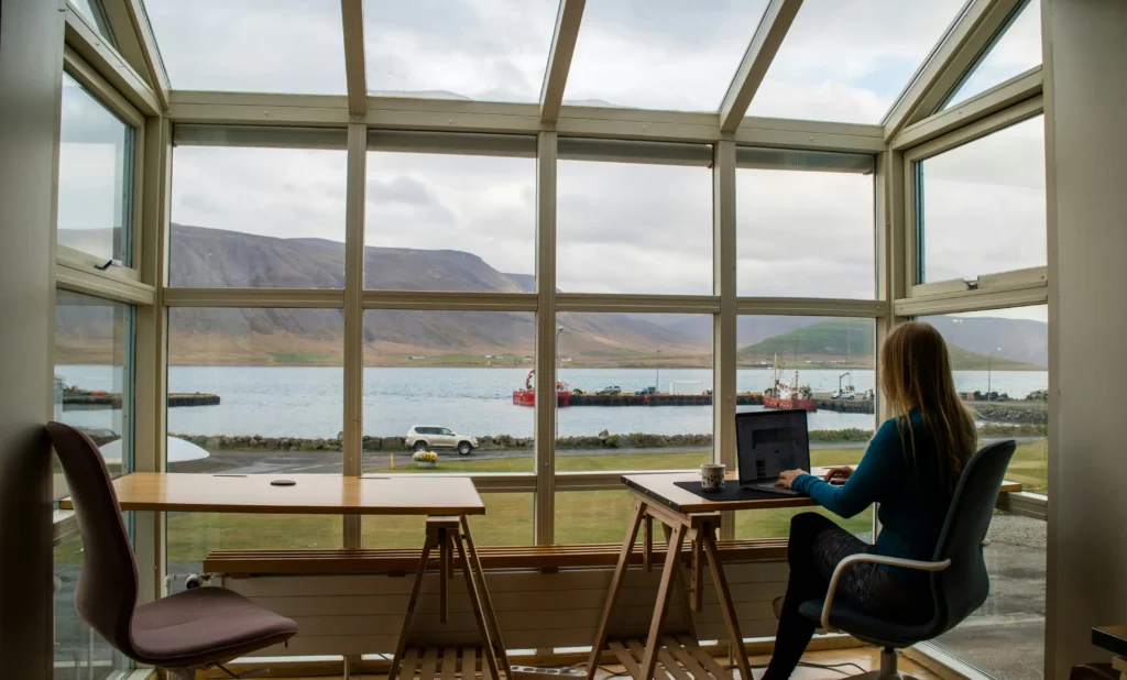 female employee enjoys remote working with a scenic view.